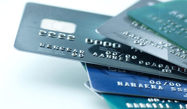Five credit cards arranged on a white background with different designs and colors